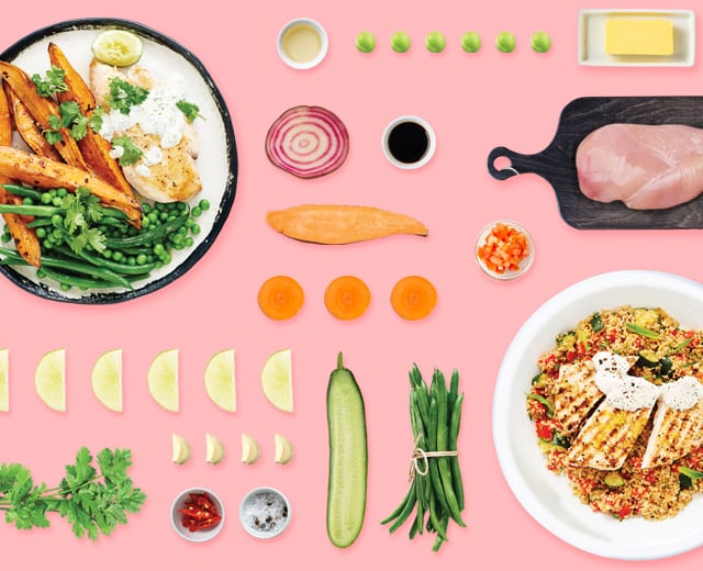 A flat lay view of plates filled with food and preportioned ingredients from Marley Spoon