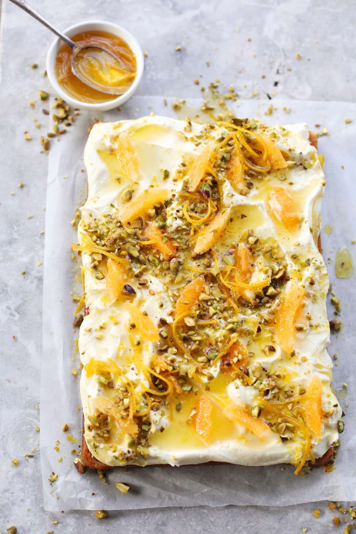 Lemon Curd Sheet Cake with Lemon Ripple Cheesecake Frosting, Candied Orange and Pistachio